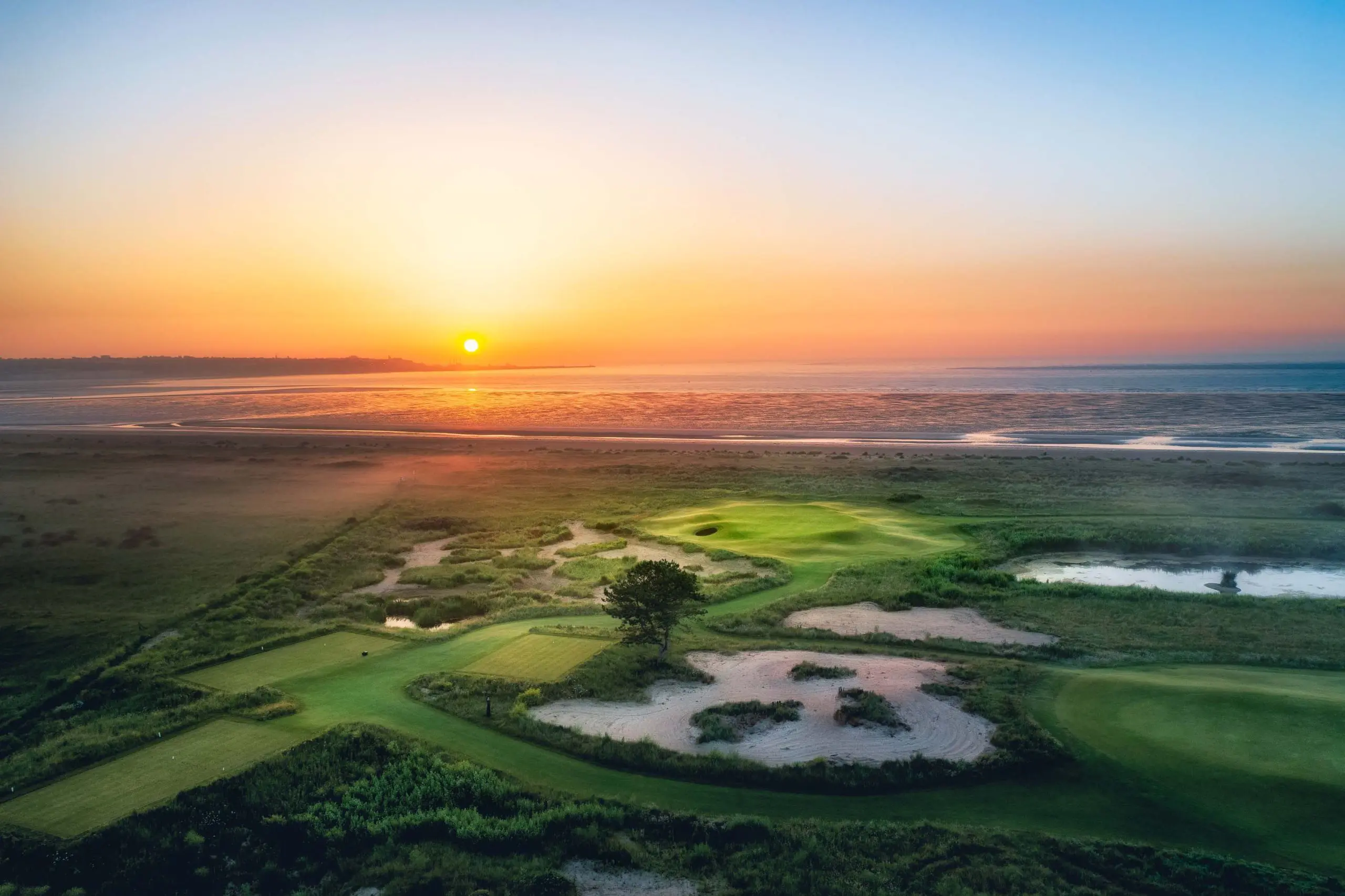 Sunrise over a links golf course