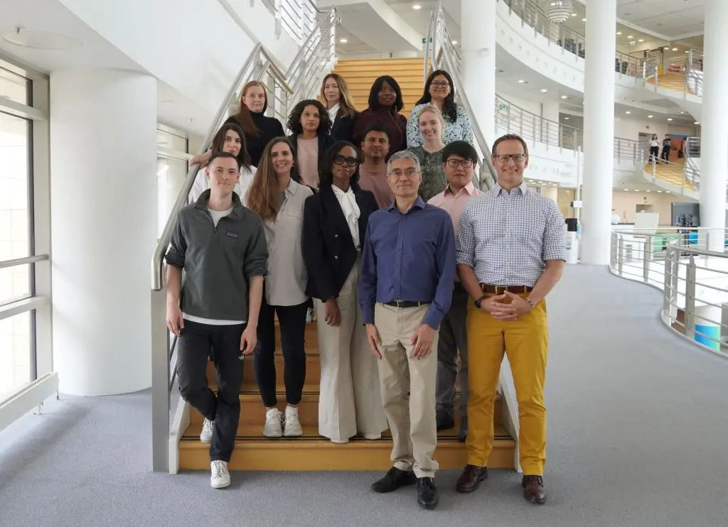A group of 14 people standing on stairs.