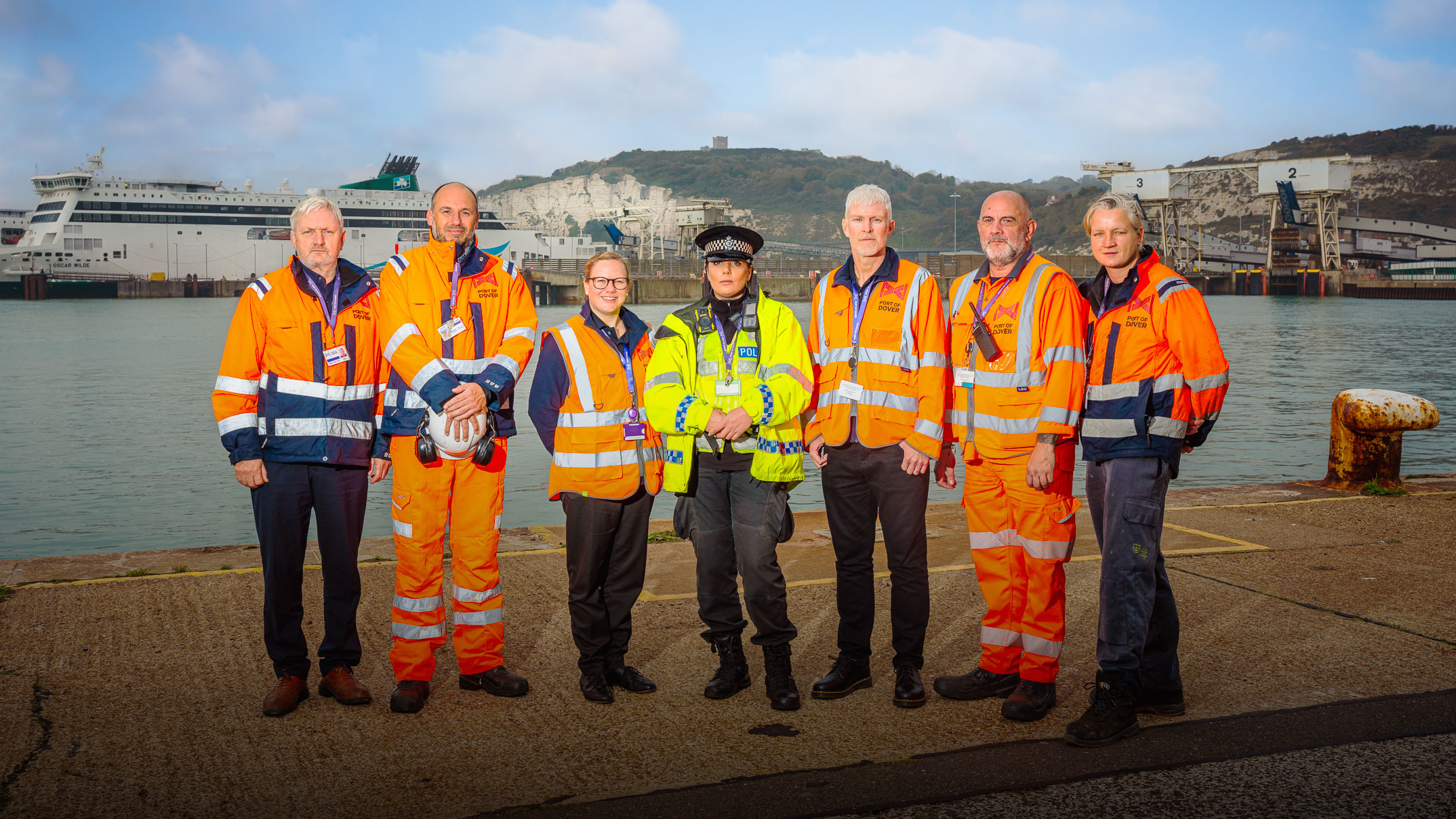 A group of seven people in high vis standing by the sea at the Port of Dover