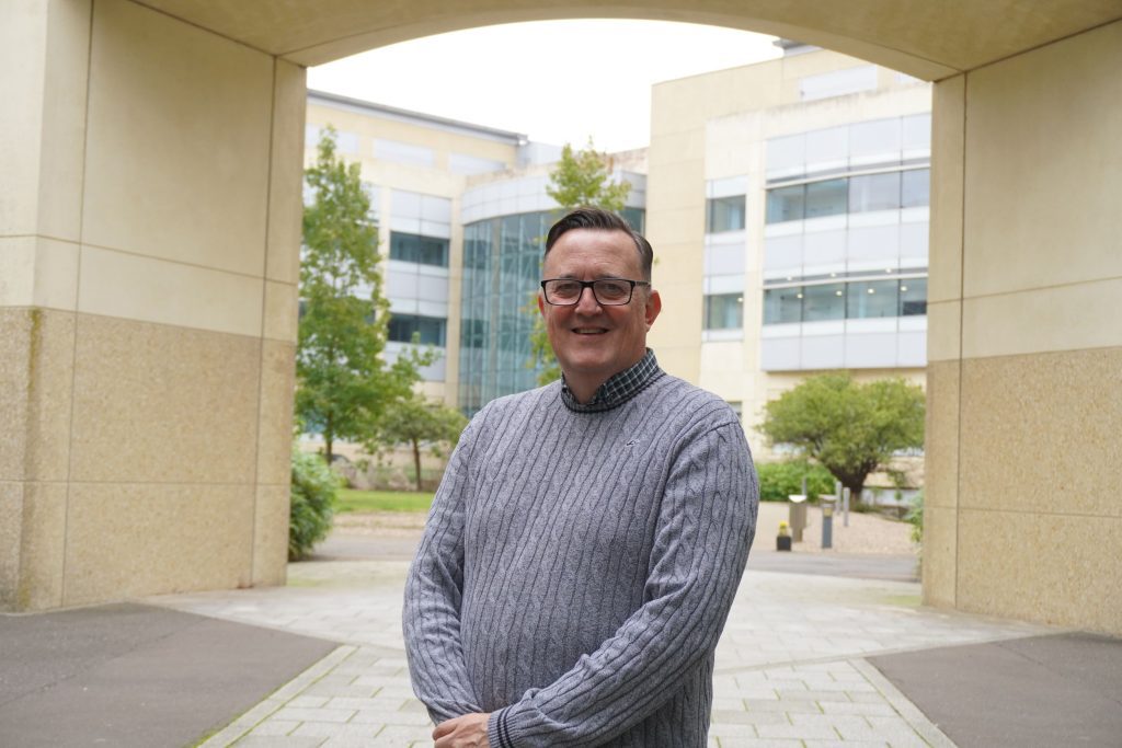 A man standing in front of the Discovery Park.